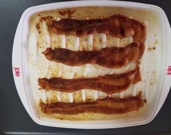 The bacon cooker loaded with four pieces of ready-to-eat crispy bacon