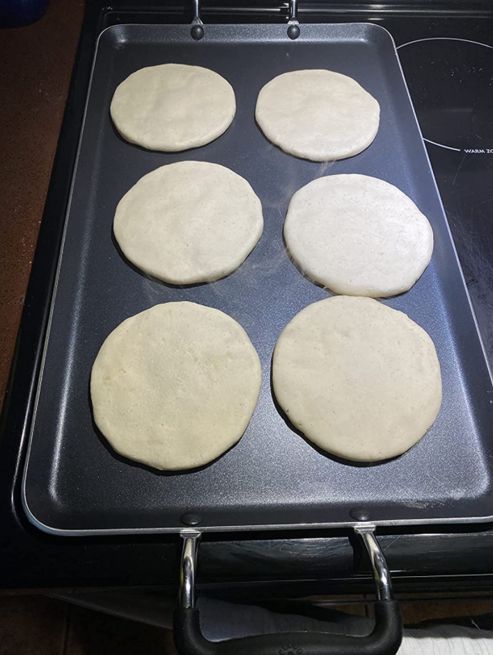 reviewer making pancakes on griddle