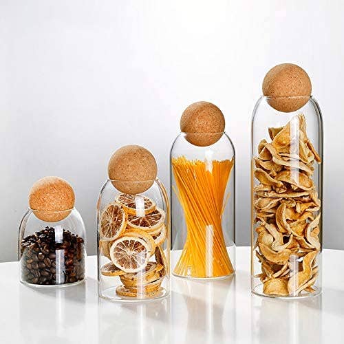 The set of four jars in different heights and cork ball tops