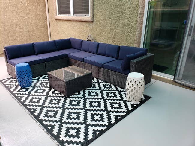 reviewer's black and white outdoor rug on a back patio
