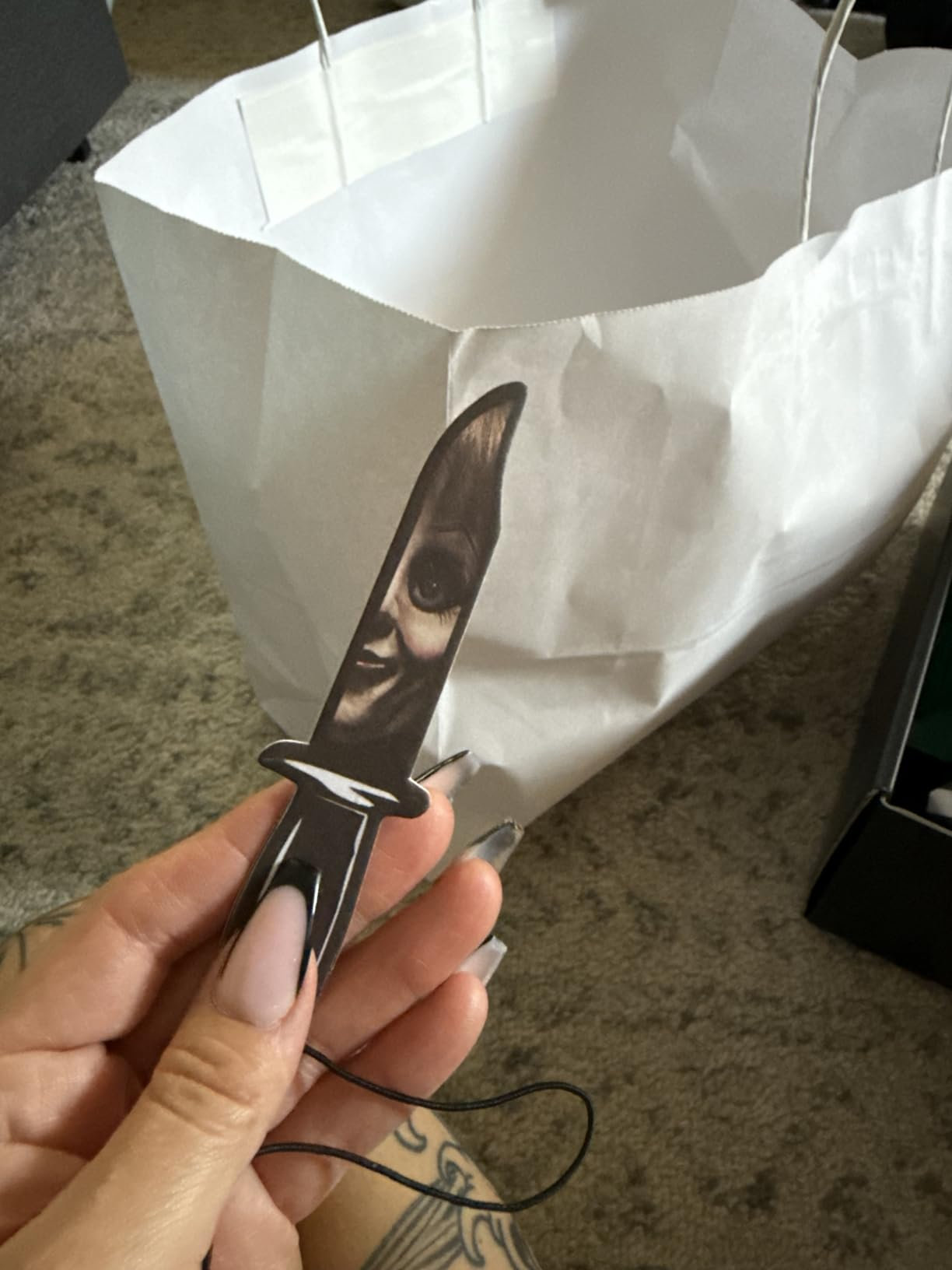reviewer holding a knife-shaped freshener with an oculus  design
