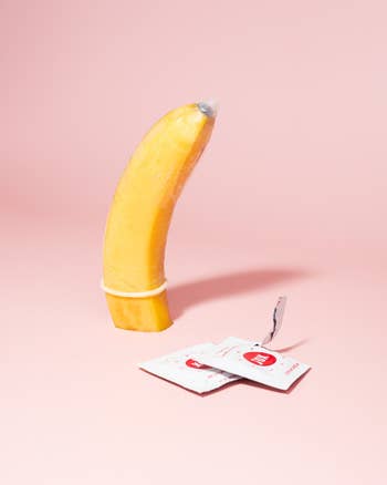 condom demonstrated on banana next to wrappers