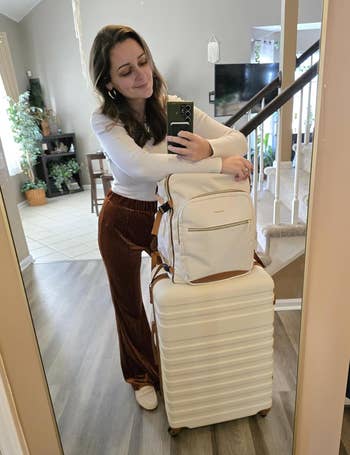 reviewer posing with suitcases 