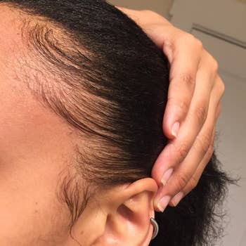 reviewer showing their edges laid down using the cream