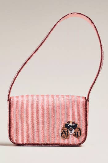 Beaded handbag with striped design and small embroidered dog face, featuring a single shoulder strap