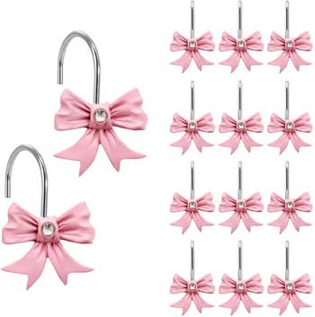 A set of shower hooks designed with pink bows and a single crystal at the center