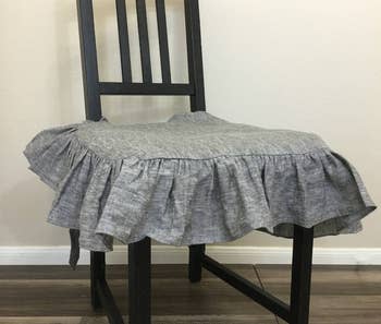 gray ruffled seat cover on dining chair