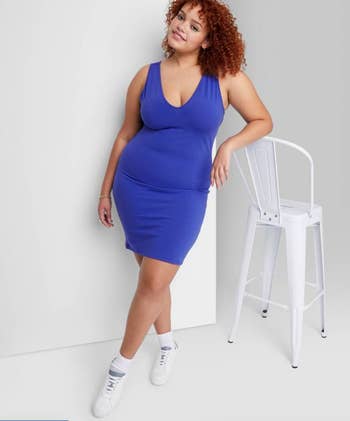 model wearing the blue dress with white socks and sneakers