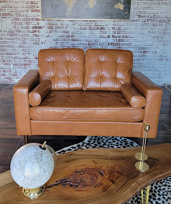 reviewer photo of the tan faux leather loveseat