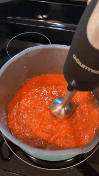 gif of the writer showing how it works to blend the soup in the pot