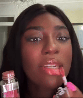 Social media trends Viral content Trending hashtags Social media updates Trending memes and videos Person applying lip gloss with a wand applicator, close-up on lips