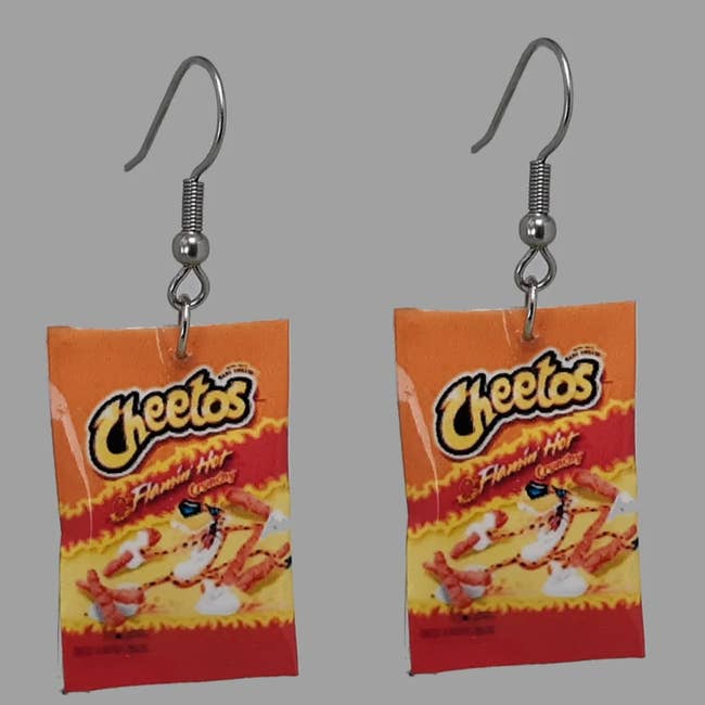 A pair of earrings in the shape of Cheeto bags 