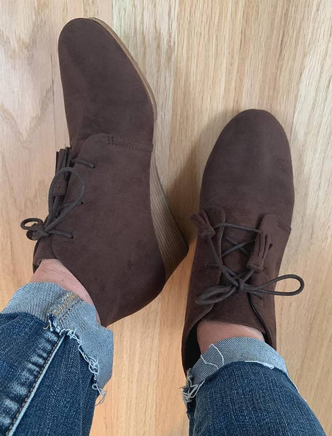 Image of reviewer wearing brown ankle boots