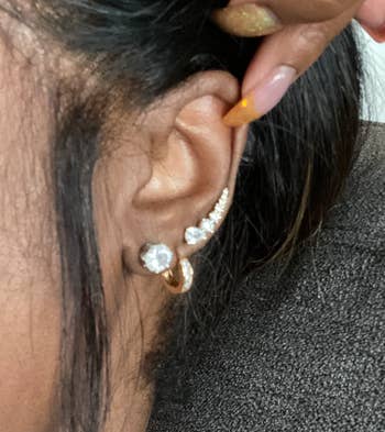 reviewer wearing ear climber in third lobe piercing