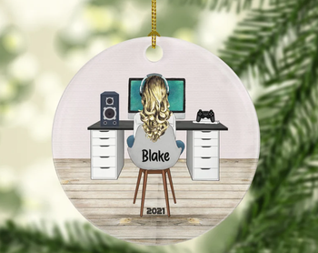an ornament of a woman sitting at a desk playing video games