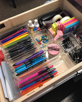 reviewer's photo of desk drawer using the organizers for pens, paper clips, etc.