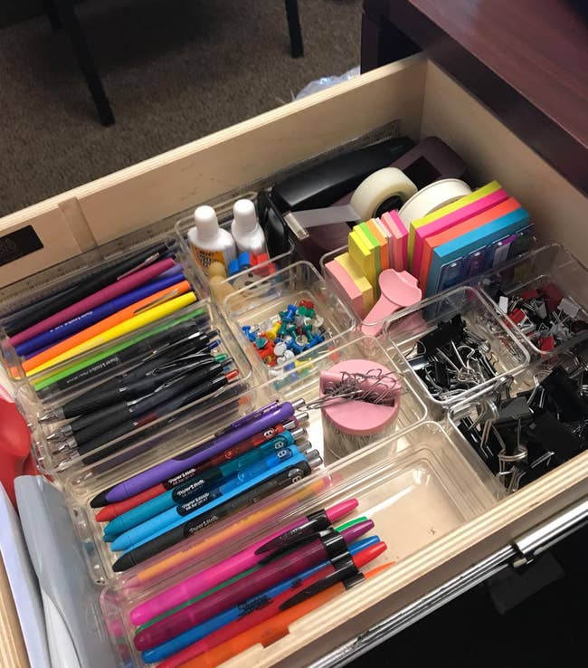Reviewer's photo of desk drawer using the organizers for pens, paper clips, etc