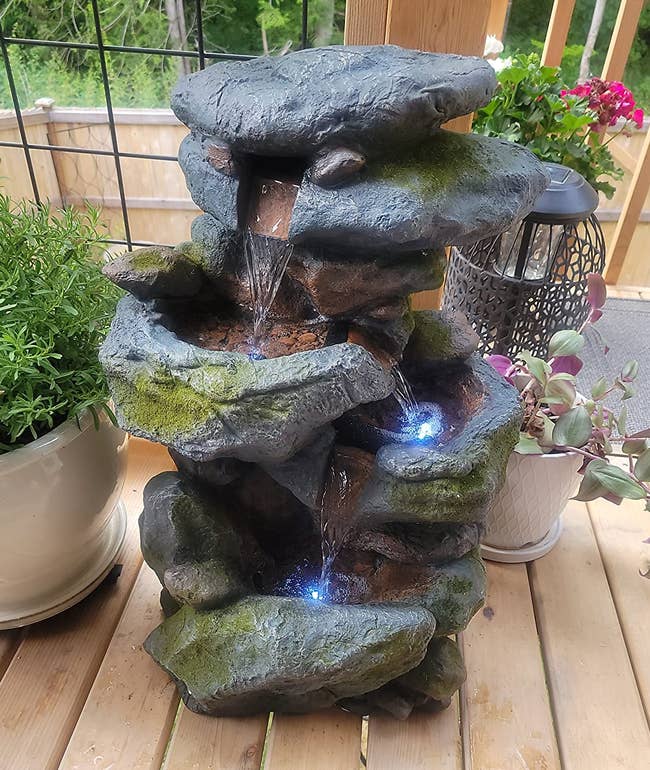 a reviewer photo of the fountain set up on a porch 