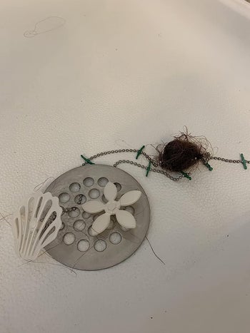 reviewer's drain wig in their shower next to a ball of hair
