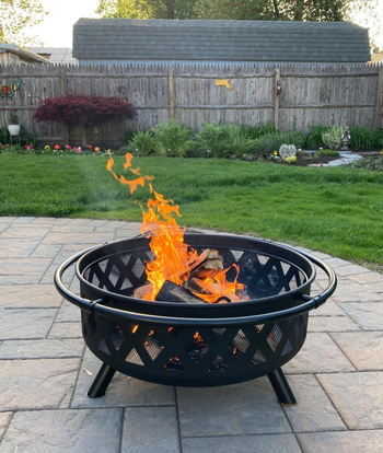 reviewer's  lit fire pit on a patio during the day