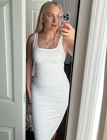 reviewer wearing the white dress