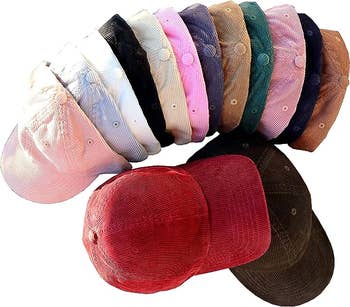 a bunch of corduroy hats in different colors