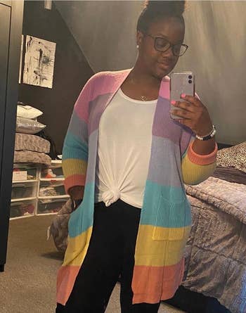 Another reviewer wearing the rainbow cardigan while taking a mirror selfie