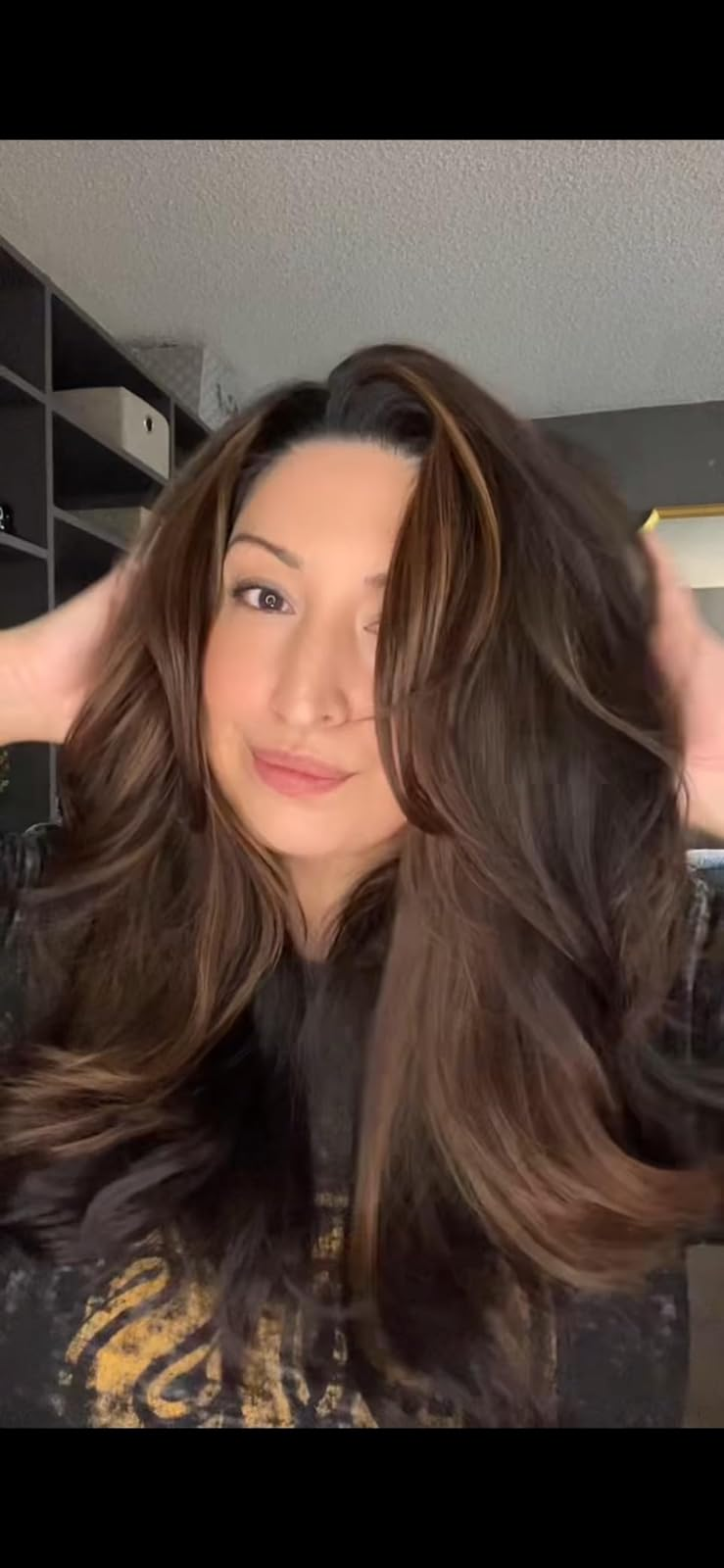 Reviewer showcasing their volumous, layered hairstyle after using the brush