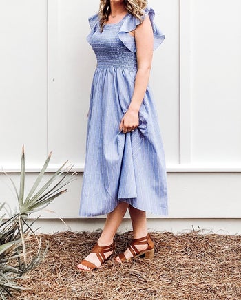 reviewer wearing the dress with tan sandals