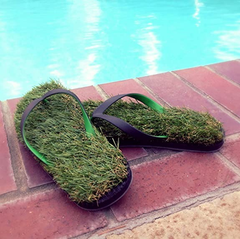 a pair of flip flops with insoles made of fake grass 