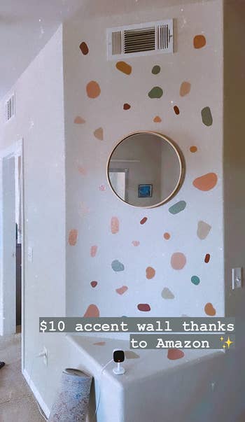 colorful terrazzo-inspired wall decals in colors like green, coral, beige, and blue on a reviewer's wall with caption over photo explaining they bought it from Amazon for $10