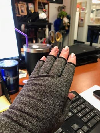 reviewer wears a compression glove on hand in front of black keyboard