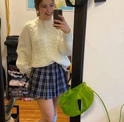 reviewer wearing the skirt in navy and white plaid