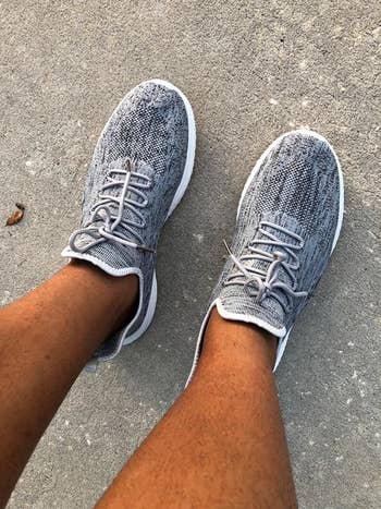 reviewer wearing the grey sneakers