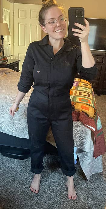 reviewer wearing the black coveralls with the pants cuffed