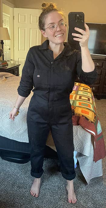 reviewer wearing the black coveralls with the pants cuffed