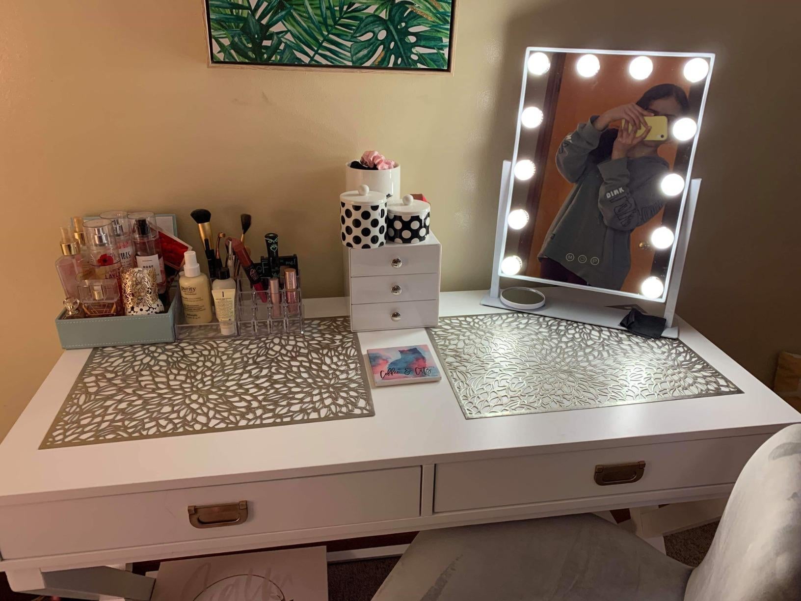reviewer photo of lit vanity mirror on a makeup table