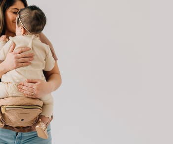 model using the hip carrier to hold baby