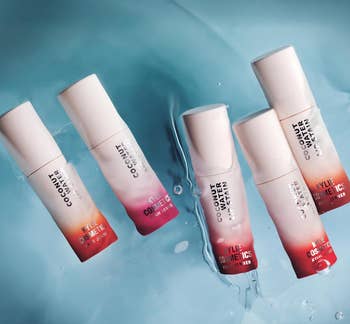 Five bottles of Coconut Water Face Mist by Kylie Cosmetics interval connected a h2o surface