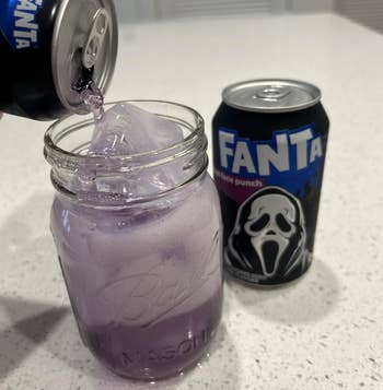 Pouring Fanta into a mason jar with ice