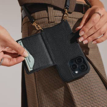 model holding the phone case, showing how the sleeve opens out and has two slots to hold cards