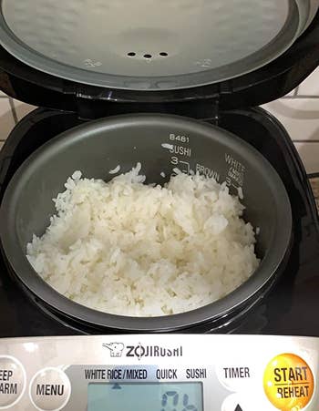 reviewer photo of the rice cooker filled with cooked white rice