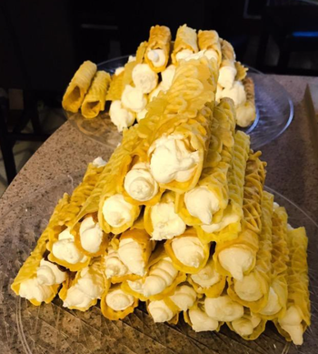 reviewer image with rolled pizzelles filled with cream