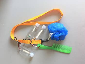 yellow lanyard with comb bottles and loofah attached with clips