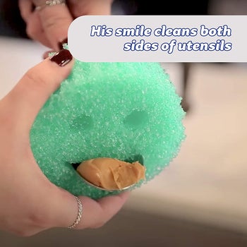 Model using the Scrub Daddy to clean a utensil, with the caption 