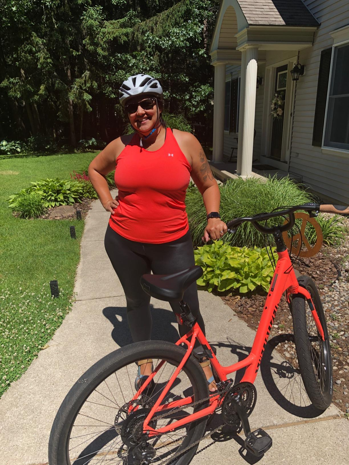 reviewer wears red Under Armour heat tech mesh tank and leggings while bike riding