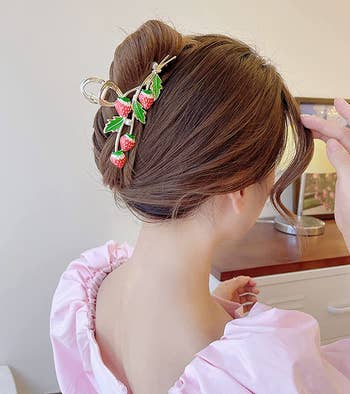 model wearing a strawberry claw clip