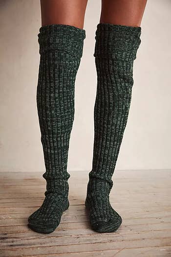 a close up of the green socks pulled up to the knees