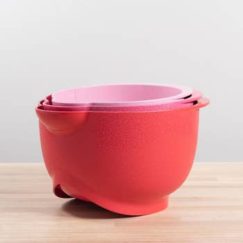 the stacking bowls together in red and two shades of pink