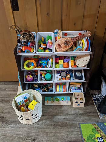 a reviewer photo of a closeup of the toy organizer with toys inside